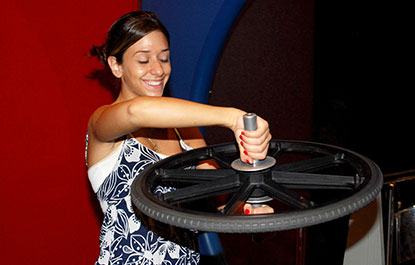 A woman learns about momentum in the Science Arcade.