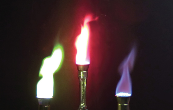 Three burners give giving off different colours of flames; green, red and purple.