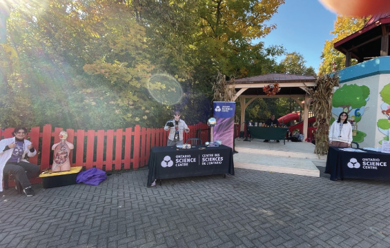 Science Centre Hosts set up at tables with science activities at Camp Spooky