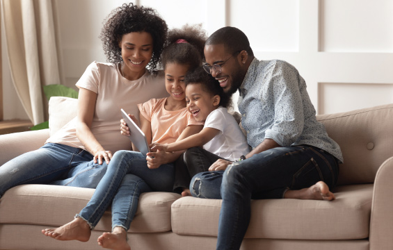 A family playing trivias on their tablet.