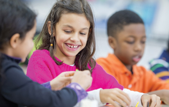 Kids working together on a science craft.