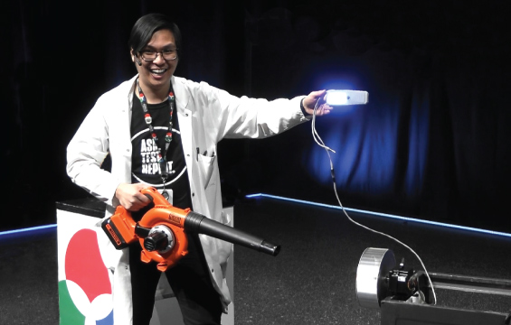 An educator presents an energy demonstration with a leaf blower.