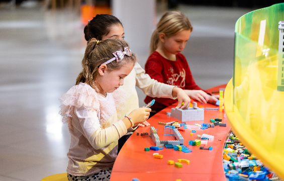 Girls playing with Lego blocks.